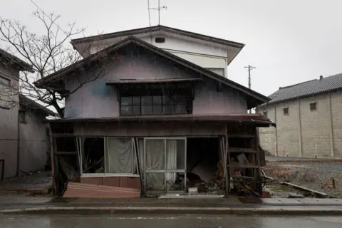 Getty Images An abandoned house sits along the main street in Fukushima prefecture