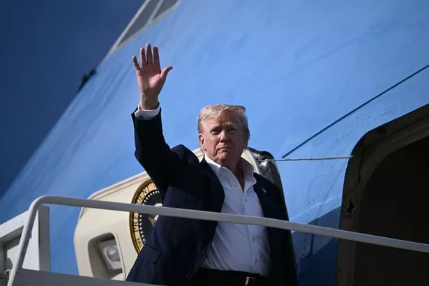 TOPSHOT - US President Donald Trump waves as he boards Air Force One at RAF Lossiemouth, north-east Scotland on July 29, 2025 at the end of his trip to Scotland. (Photo by Brendan SMIALOWSKI / AFP) (Photo by BRENDAN SMIALOWSKI/AFP via Getty Images) 