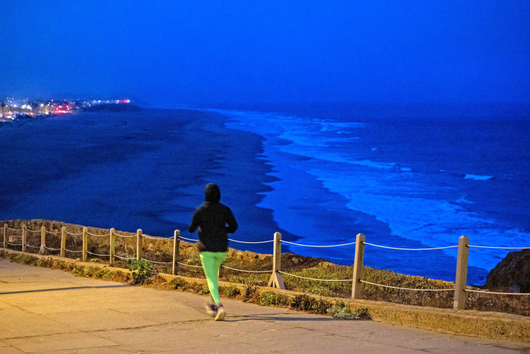 A person exercises along Ocean Beach, after authorities warned residents of the possibility of tsunami waves, following an earthquake at Russia's Kamchatka Peninsula, in San Francisco, California