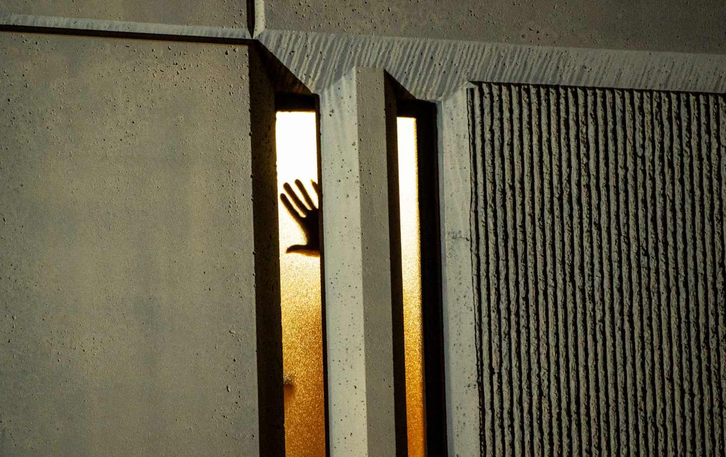 A person places their hand on a window inside a jail as demonstrators make noise outside during an anti-police protest on January 24, 2021 in Tacoma, Washington.