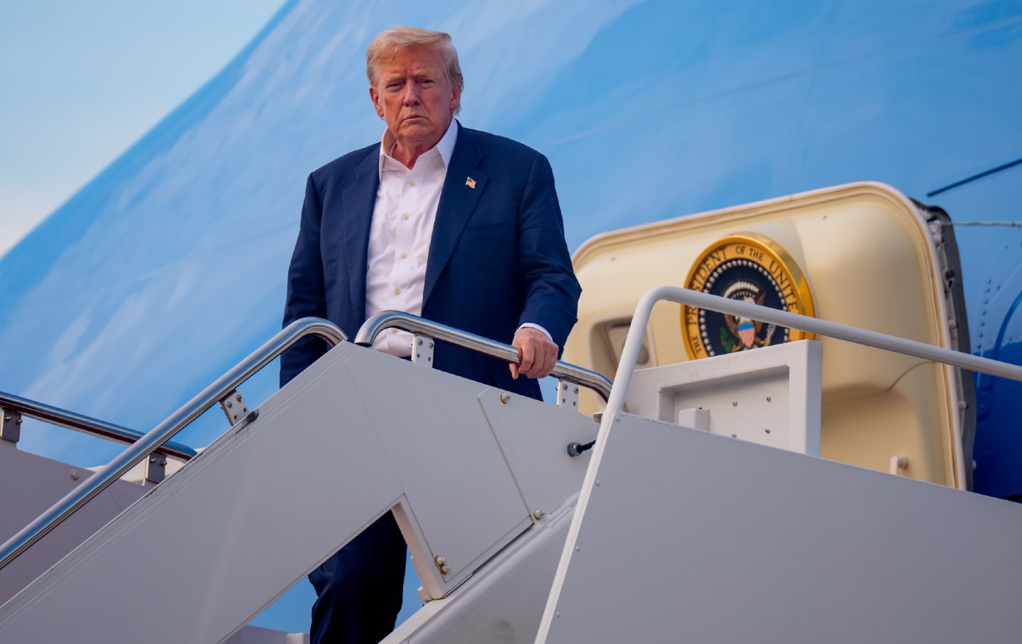 US President Donald Trump walks on the South Lawn of the White House after arriving on Marine One in Washington.