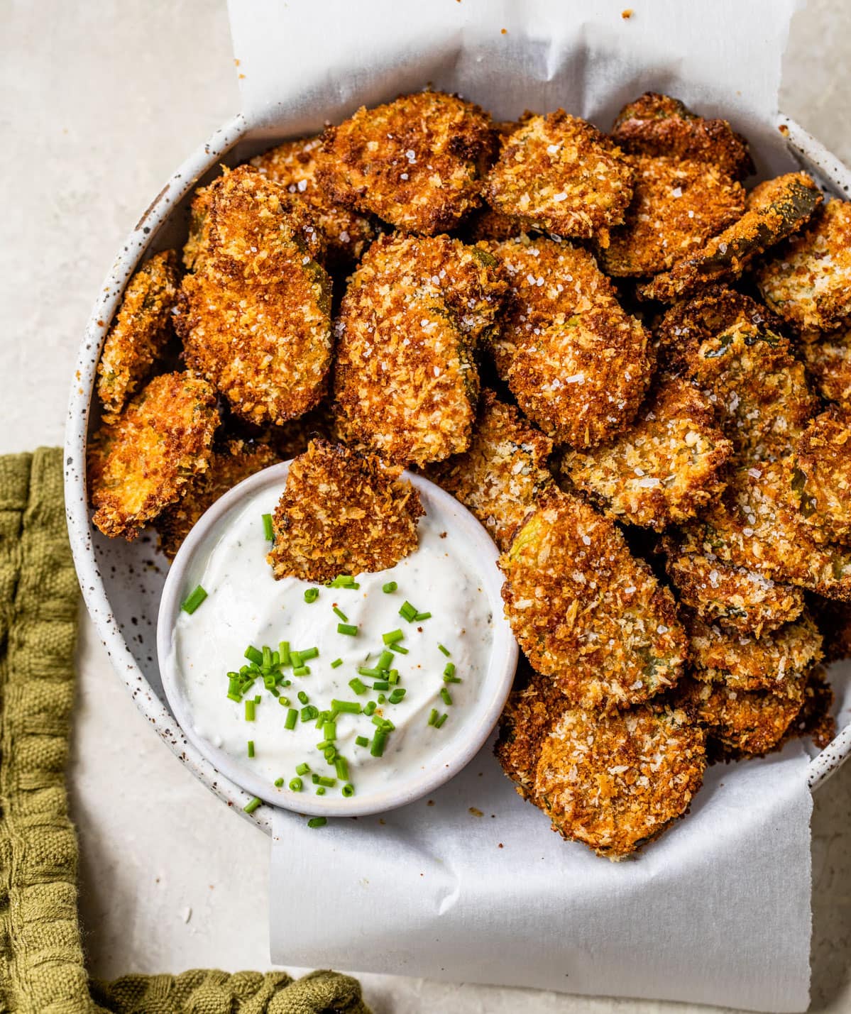 Healthy air fryer pickles in a bowl with dip