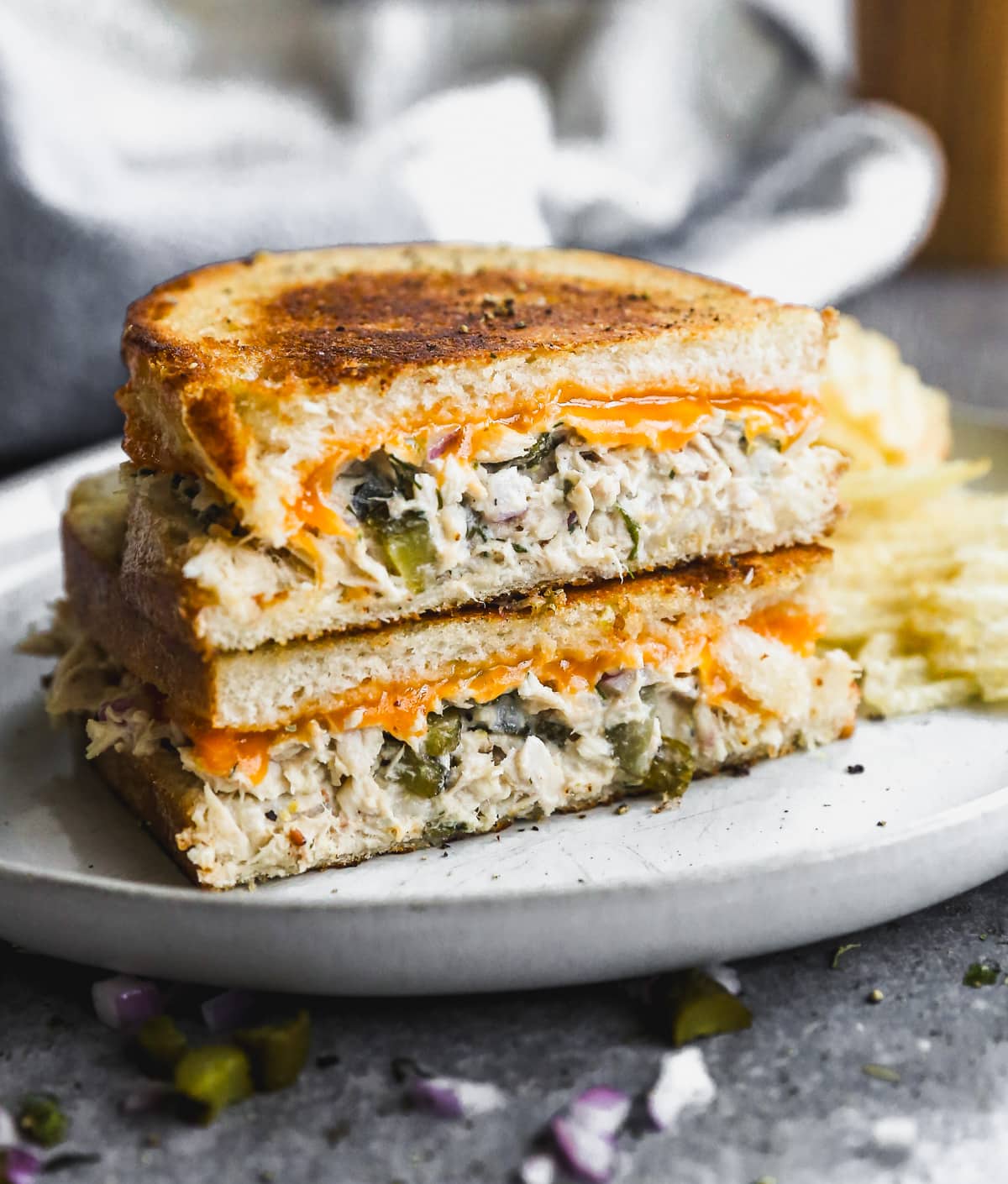 Tuna melt on plate with potato chips