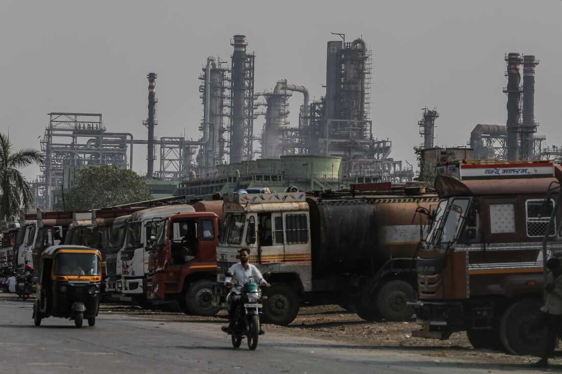 Oil tanker trucks sit outside an oil refinery operated by Bharat Petroleum Corp. Ltd., in Mumbai, India.
