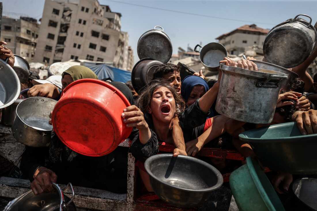 A charity distributes meals to Palestinians facing food shortages amid ongoing Israeli attacks and severe restrictions in Gaza City, Gaza on July 28, 2025.