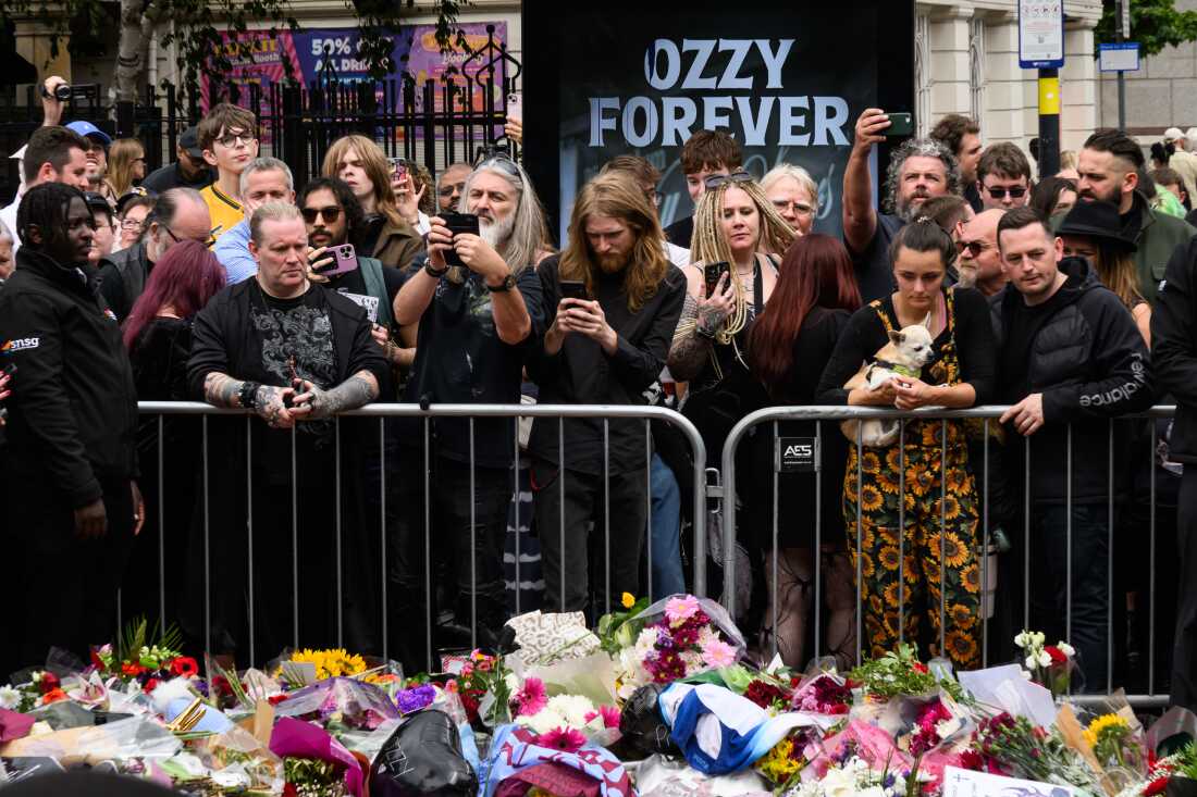 Fans gather at Black Sabbath Bridge after members of the Osbourne family visit to view tributes to the late Ozzy Osbourne as his funeral cortege traveled through his home city of Birmingham, England, on Wednesday. His death occurred just a little over two weeks after his final live performance at the "Back to the Beginning" concert in his hometown of Birmingham.