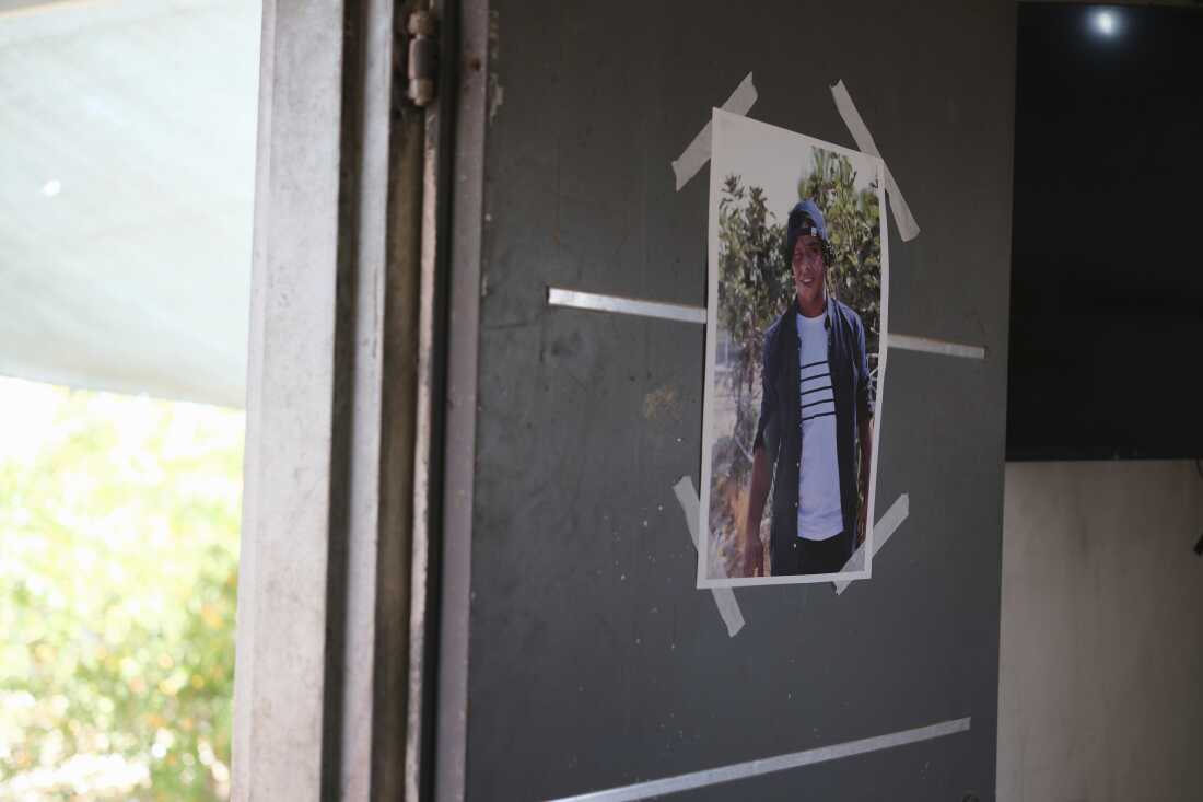 A photo of Palestinian activist Awdah Al Hathaleen, who witnesses say was killed by an Israeli settler, hangs in the entrance to his home in the village of Umm al-Khair, West Bank, Monday, Aug. 4, 2025.