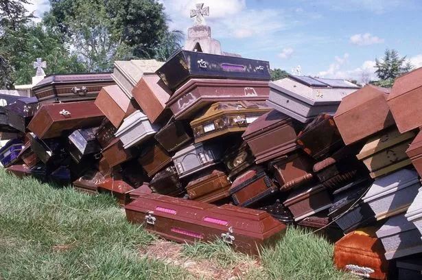 View of empty coffins piled in a graveyard, Guayabal, Colombia, mid November 1985. The coffins were gathered for the victims of the mudslide set off by the eruption of the nearby Nevado del Ruiz volcano which claimed over 25,000 lives. (Photo by Robert Nickelsberg/Getty Images)