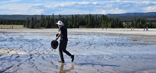 Man trampling over delicate eco-systems near the Grand Prismatic Spring in Yellowstone National Park, Wyoming