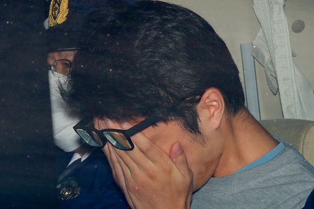 Takahiro Shiraishi leaving a police station in 2017