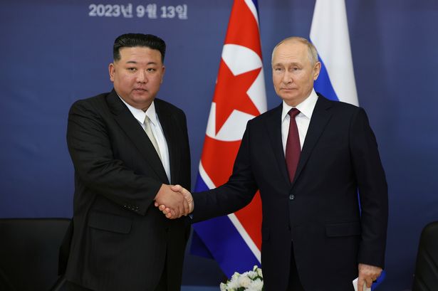 Kim and Putin shake hands