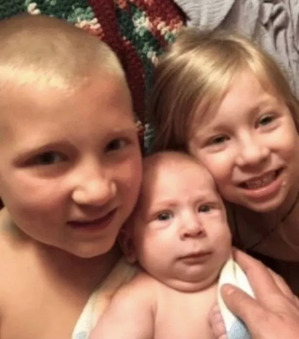 six-month-old Colson (center) and six-year-old Grayson, (right) and his half-sister Aurora, aged five (right) 