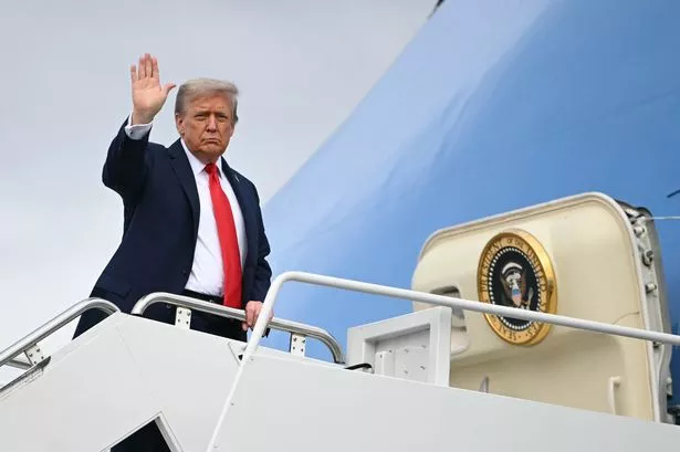 US President Donald Trump waves as he boards Air Force One