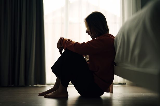 Silhouette of woman in bedroom.