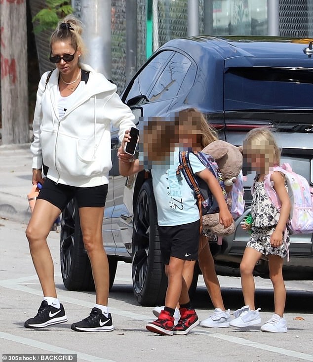 Former tennis icon Anna Kournikova, 44, is pregnant with her fourth child - above is the last time she was pictured in public, out with her three children in Miami earlier in August