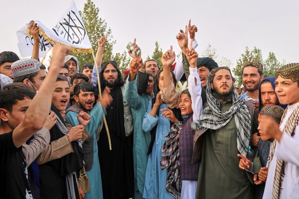 Afghans chant during celebrations marking the fourth anniversary of the US withdrawal