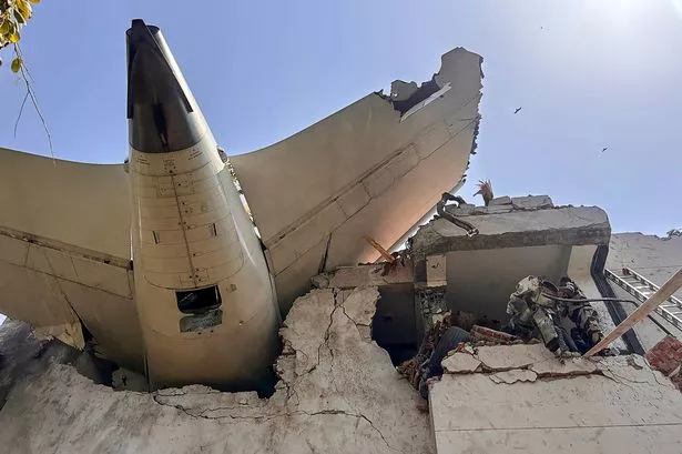 The tailpiece of Air India flight AI171 after it crashed in a residential area