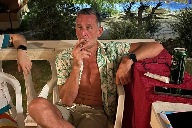 Craig Bloomer smoking a cigar on holiday