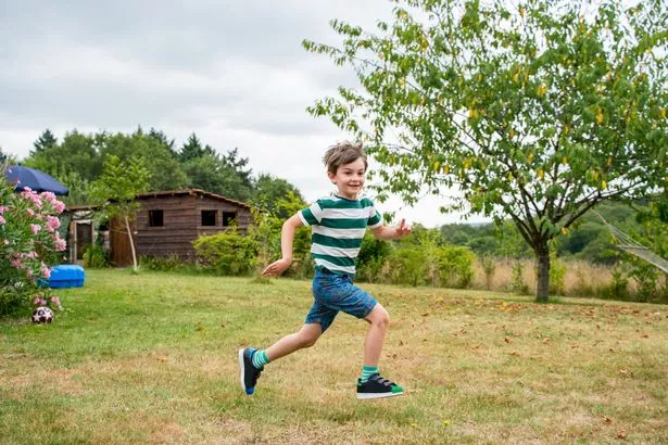 A child running through a garden