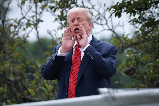 WASHINGTON, DC - AUGUST 05: U.S. President Donald Trump shouts answers to questions from reporters as he tours the roof of the West Wing of the White House on August 05, 2025 in Washington, DC. Trump has undertaken several renovation projects at the White House to include the construction of a concrete patio at the Rose Garden. (Photo by Win McNamee/Getty Images)