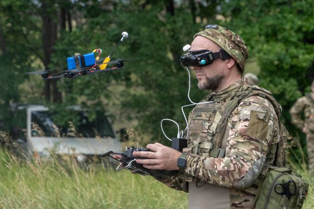 A Ukrainian serviceman controls an FPV drone at the frontline in Kharkiv