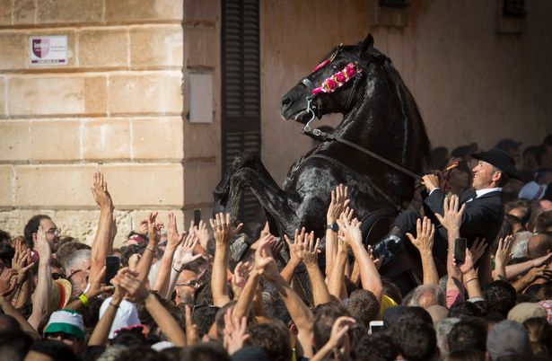 A horse rears in the crowd during the "Caragol des Born", a mass gathering of horses and people swirling to the rythm of the music during the traditional Sant Joan (Saint John) festival in the town of Ciutadella, on the Balearic Island of Minorca, on the eve of Saint John's day on June 23, 2023