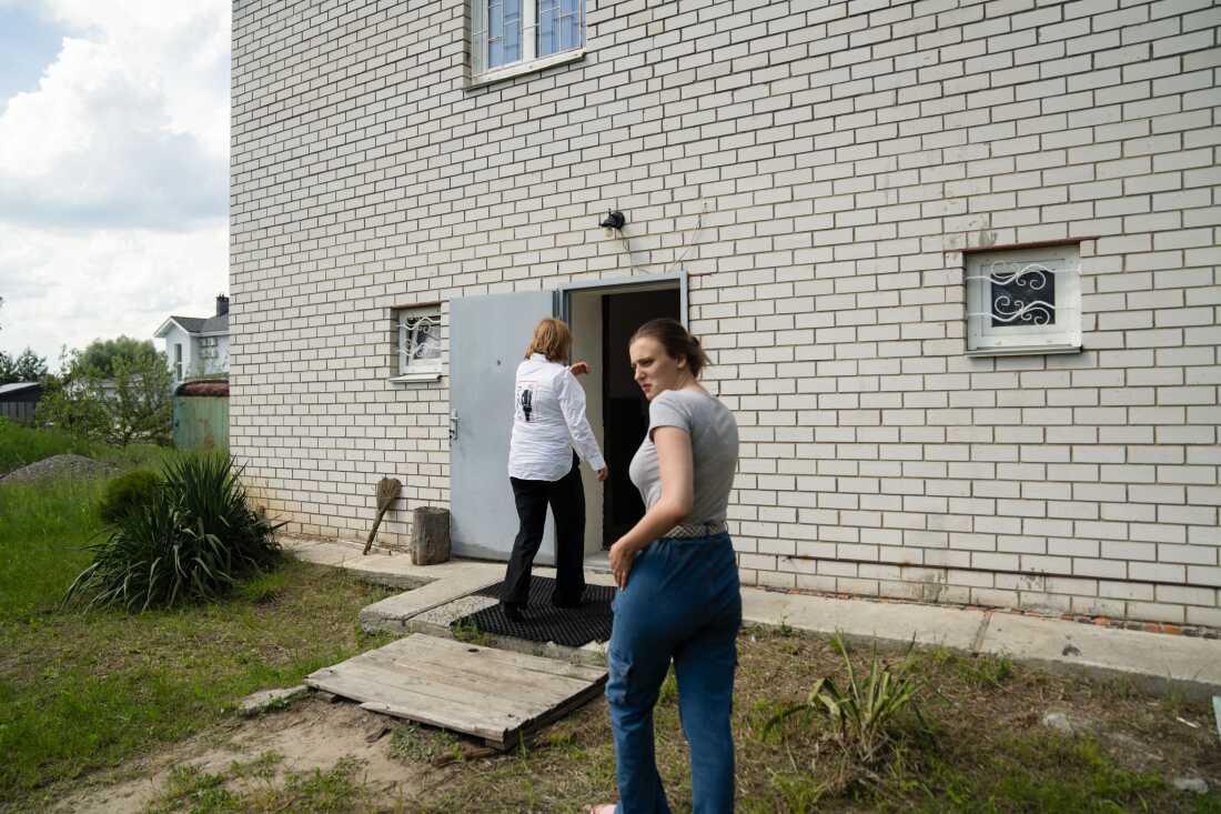 Liia Kazakova follows her mother as they enter the home where she’s staying.