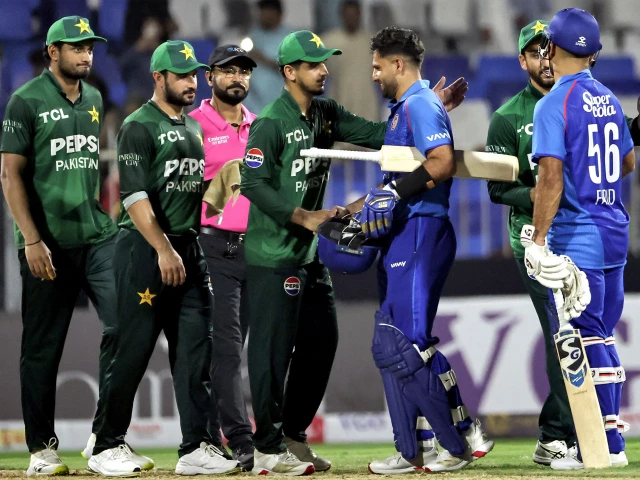 pakistan and afghanistan s players shake hands at the end of their uae tri series match in sharjah photo afp