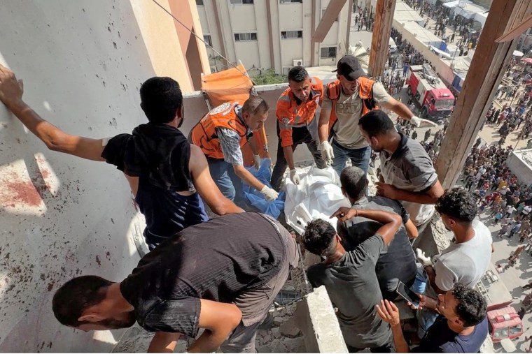 Palestinians inspect the site of Israeli strikes on Nasser Hospital where Reuters contractor was killed, in Khan Younis