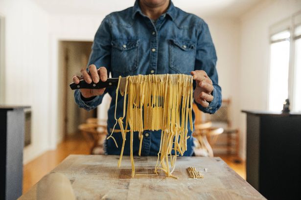 Mid section of person making homemade pasta