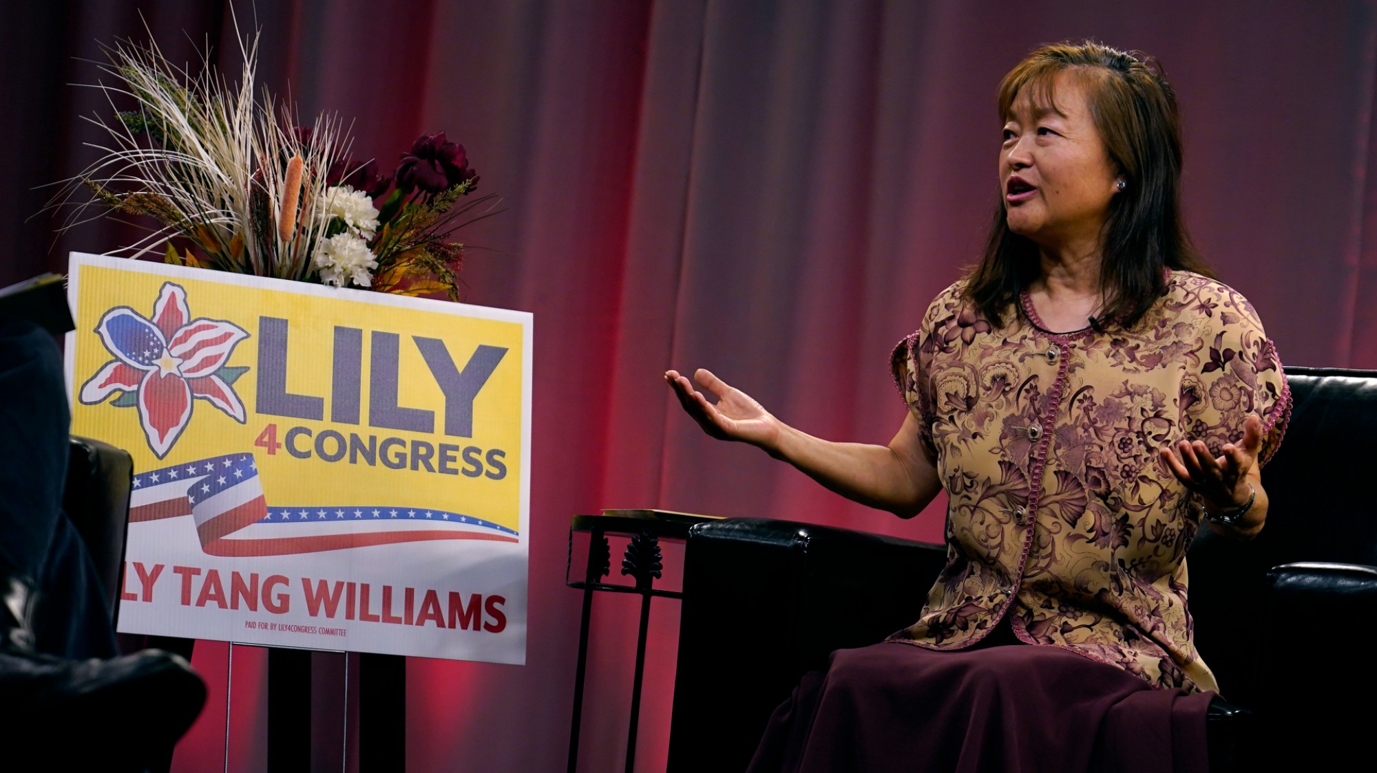 Lily Tang Williams sits in a chair during a televised interview.
