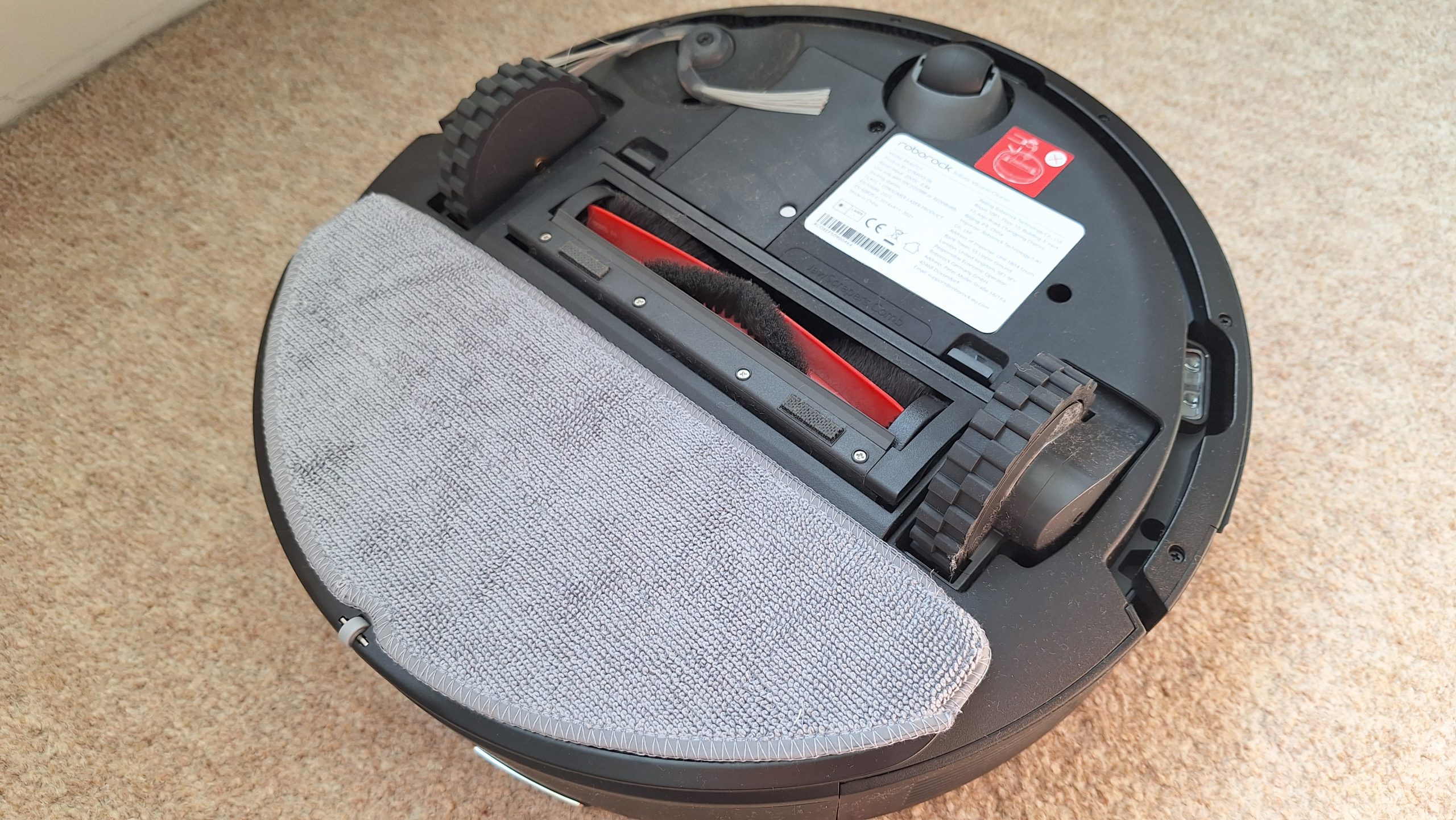 Roborock Q7 M5 robot vacuum flipped over to show underside