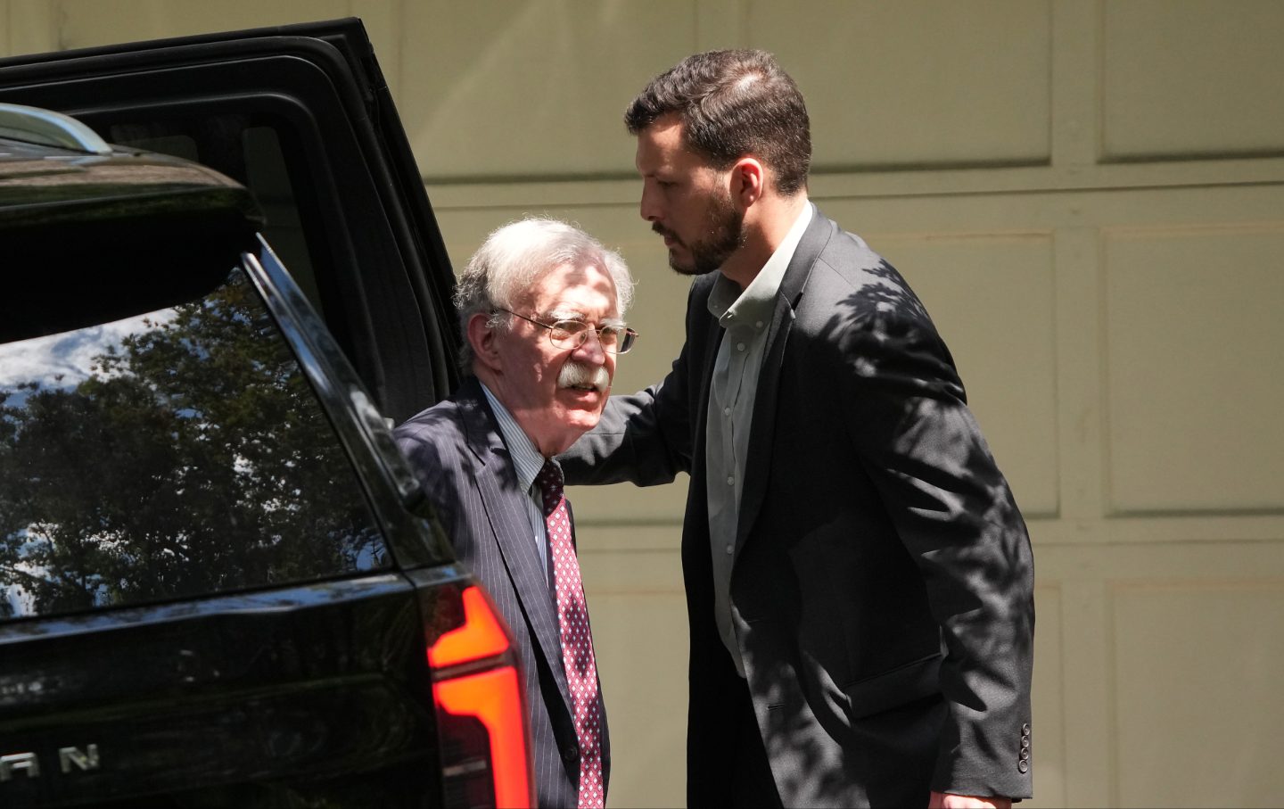 ohn Bolton, former national security adviser to President Trump, arrives home, as the FBI searches his house August 22, 2025 in Bethesda, Maryland.