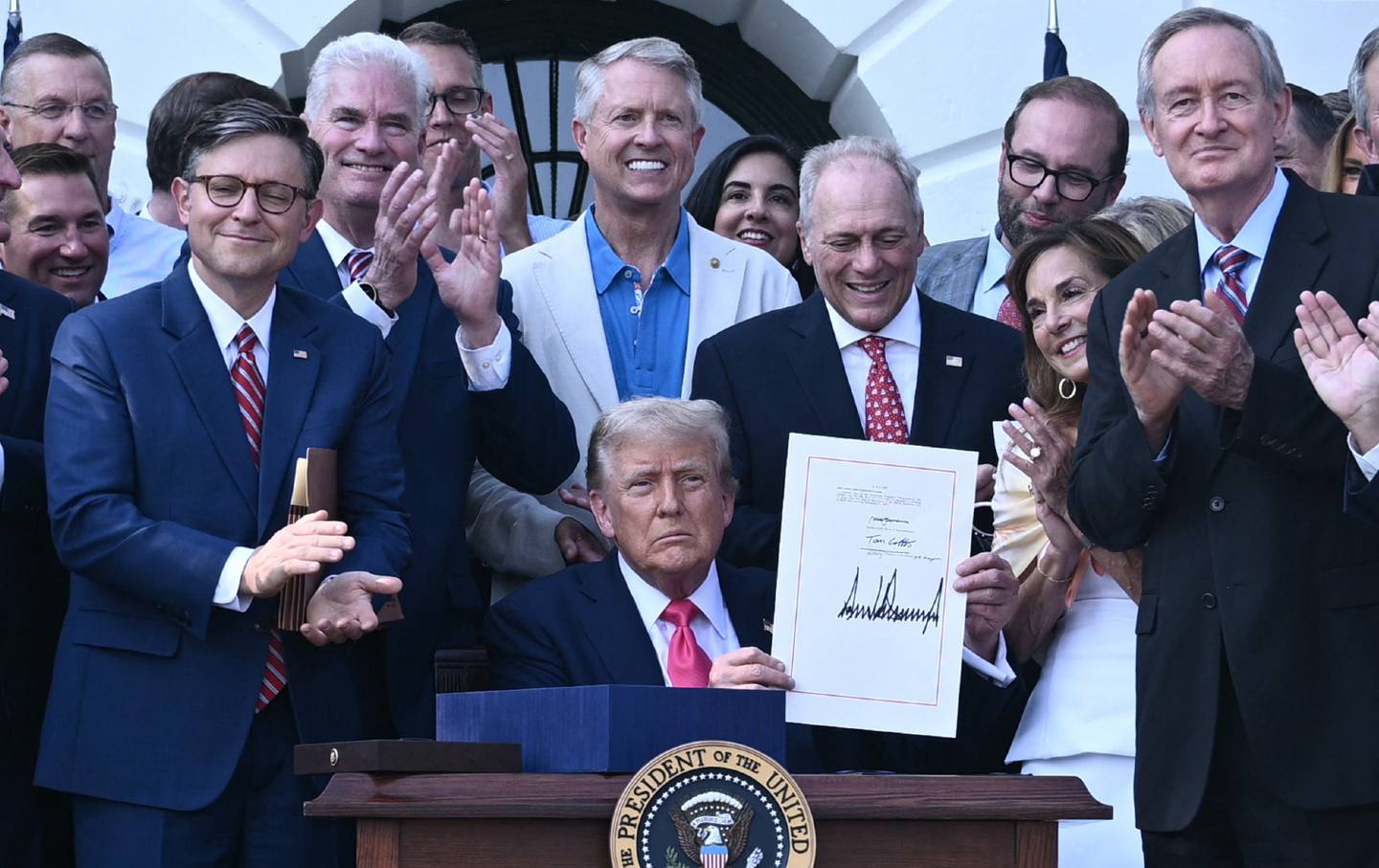 Donald shows his signature on the "Big Beautiful Bill Act