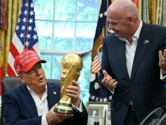 us president donald trump alongside fifa president gianni infantino holds the world cup trophy in the oval office