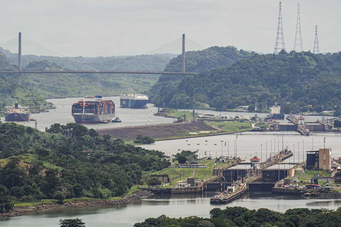 A cargo ship navigates through the Panama Canal, seen from the Cerro Ancon in Panama City.