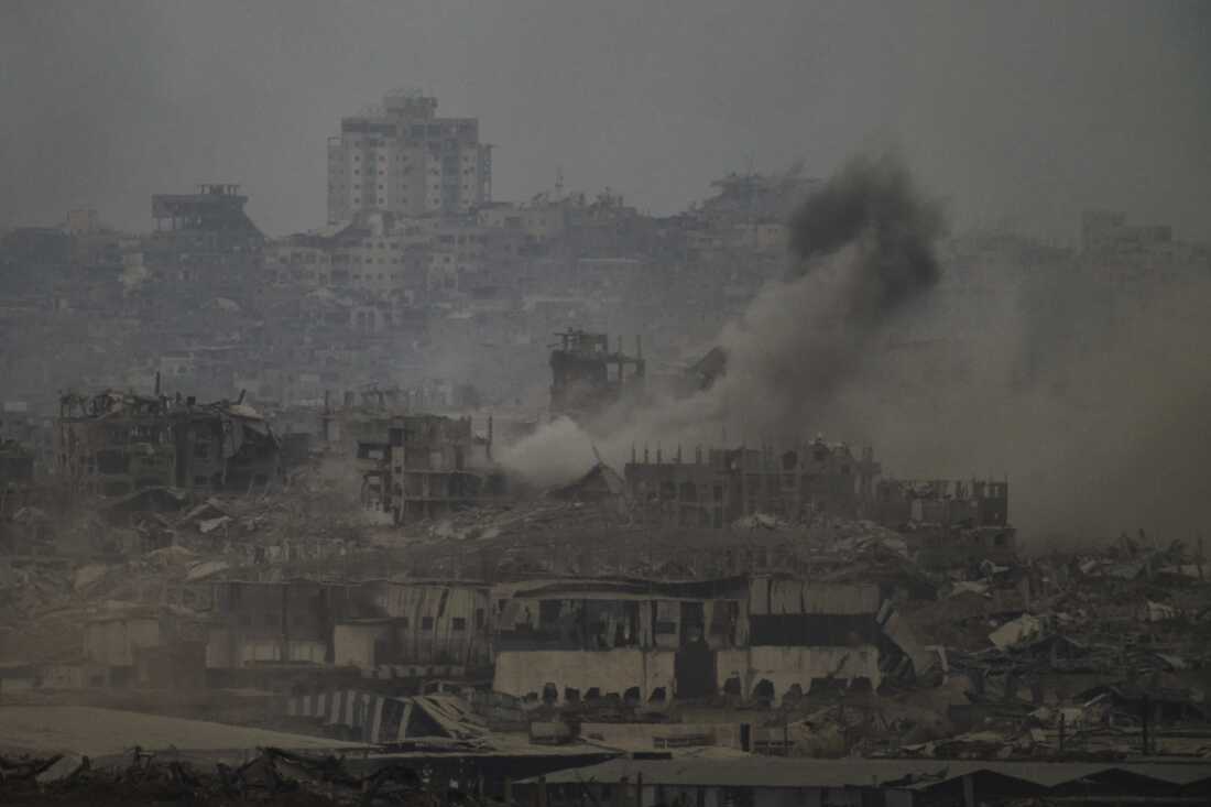 Smoke rises amid destroyed buildings following an Israeli shelling in the Gaza Strip, as seen from southern Israel, Friday, Aug. 1, 2025.
