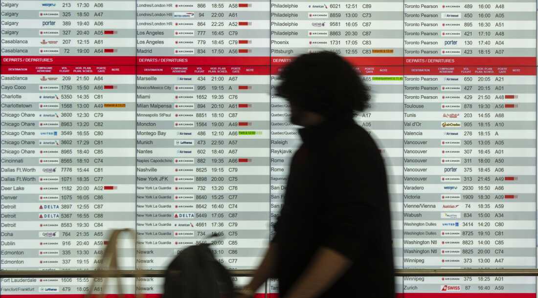 Cancelled and delayed Air Canada flights are seen on the departure board at Montreal-Pierre Elliott Trudeau International Airport on Friday.