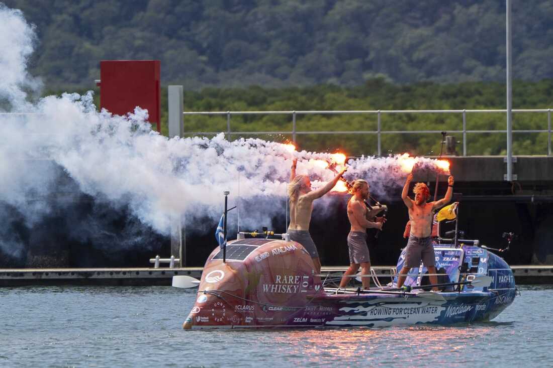 Scottish brothers, Ewan, Jamie and Lachlan, Maclean react after completing their record-breaking row from Peru across the Pacific Ocean to Cairns, Australia, on Saturday