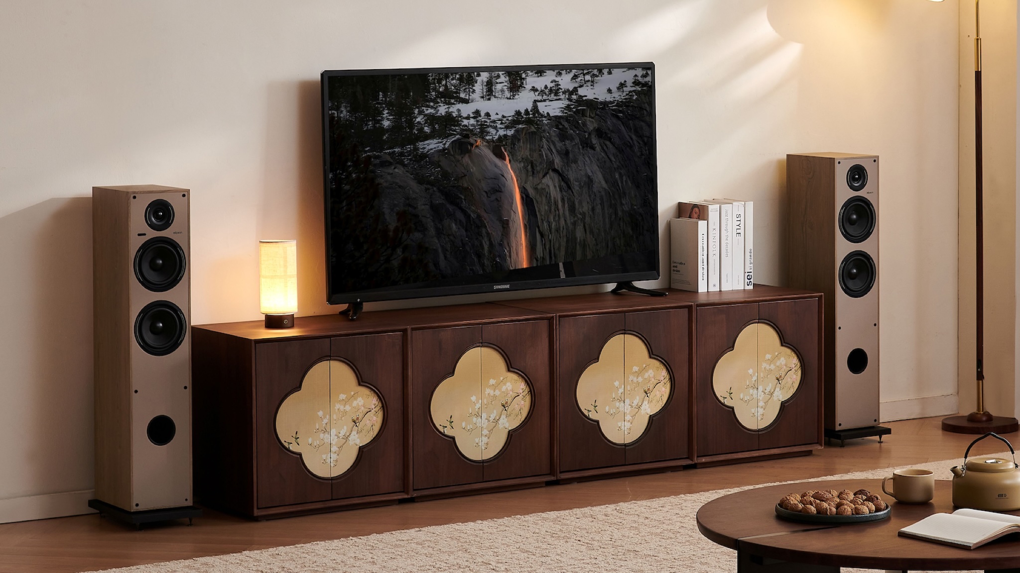 Elipson Horus 11F Active floorstanding speakers on either side of a rather flamboyant sideboard with a TV on top of it