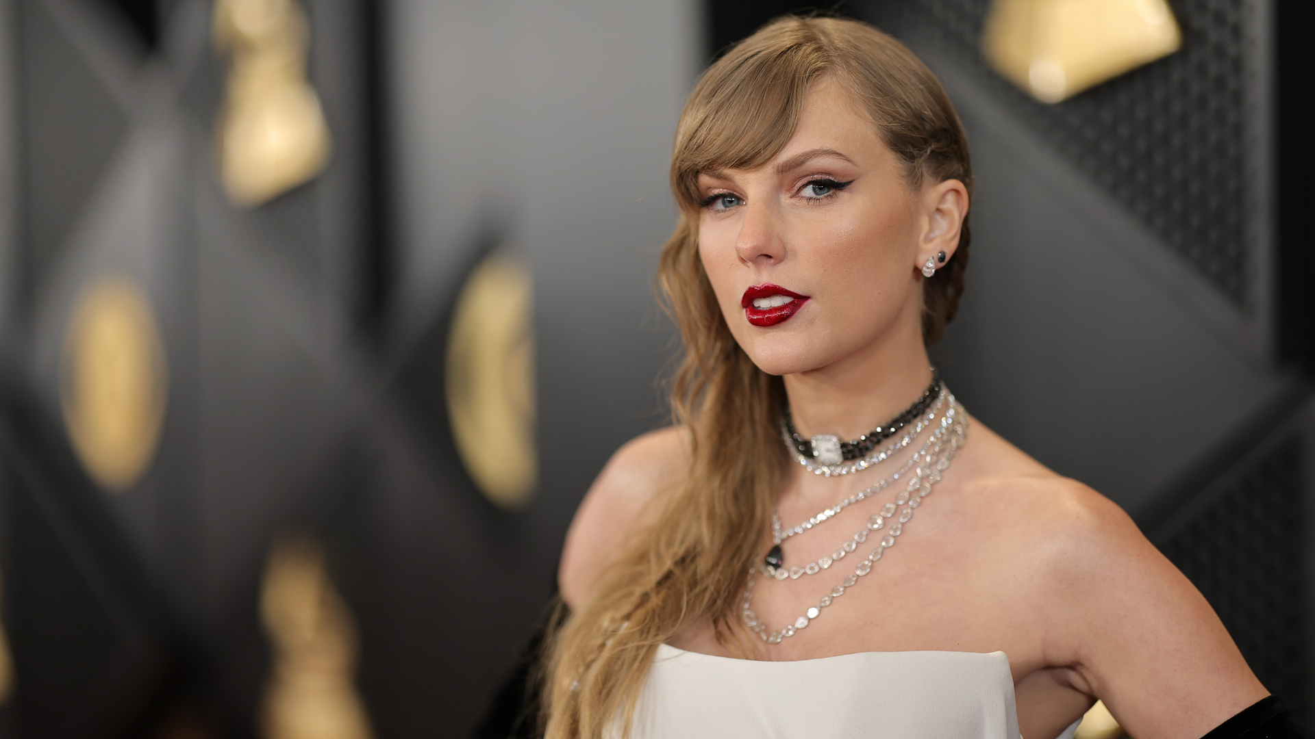 A close up shot of Taylor Swift on the 2024 Grammys red carpet