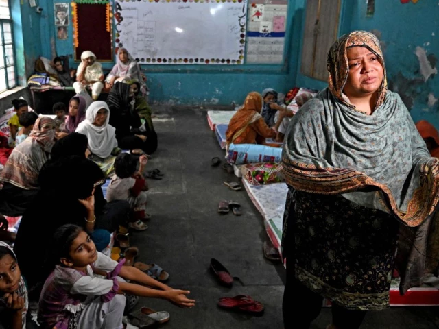 tabassum suleman an evacuated resident from her submerged home speaks during an interview with afp as she takes shelter at a government school after floodwaters entered from the overflowing ravi river in shahdara lahore on august 29 2025 the women you see here and me we had to run for our lives we did not even get the time to get clothes for our kids 40 year old widow tabassum suleman told afp from the school camp monsoon rains this week have swelled three transboundary rivers that cut through pakistan s eastern province the nation s agricultural heartland and home to nearly half of its 255 million people photo afp