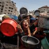A charity distributes meals to Palestinians facing food shortages amid ongoing Israeli attacks and severe restrictions in Gaza City, Gaza Strip, on Monday.
