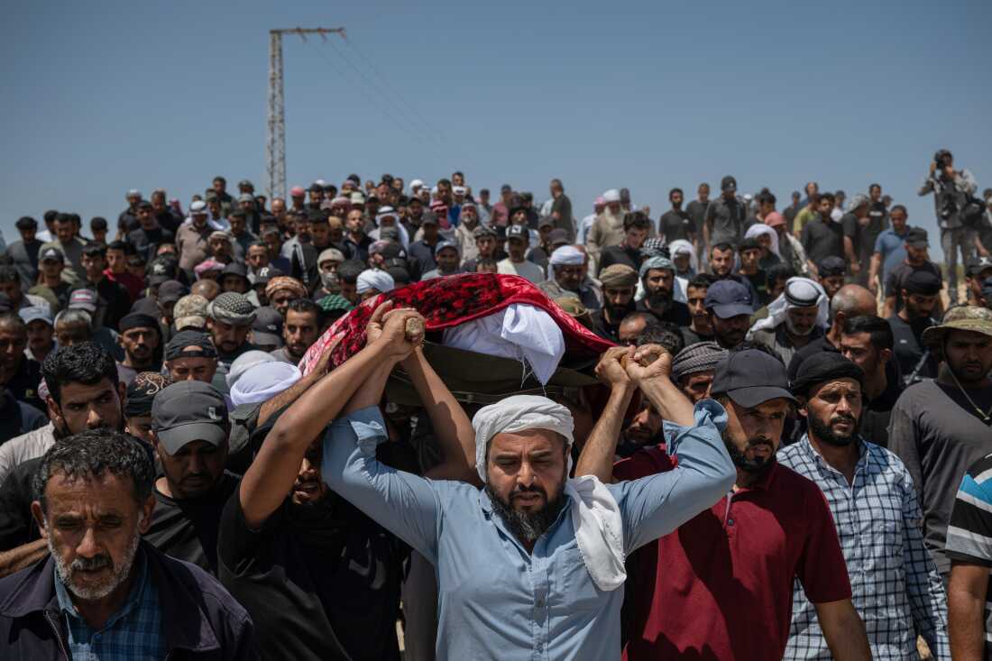 Family and friends of Awdah Hathaleen carry his body to the cemetery during his funeral on Aug. 7, 2025 in Umm al-Kheir, West Bank. The 31-year-old Palestinian activist and father of three was killed on July 28 when Israeli settler Yinon Levi allegedly opened fire during a confrontation in the Bedouin village of Umm al-Kheir (or Umm al-Khair), in the Masafer Yatta region of the occupied West Bank.