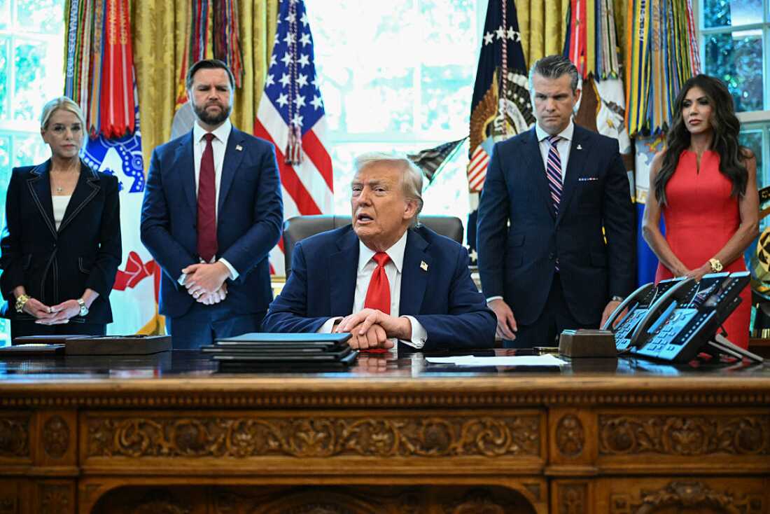 President Trump speaks to the press before signing executive orders at the White House on Monday, as Attorney General Pam Bondi, Vice President Vance, Defense Secretary Pete Hegseth and Secretary of Homeland Security Kristi Noem look on.