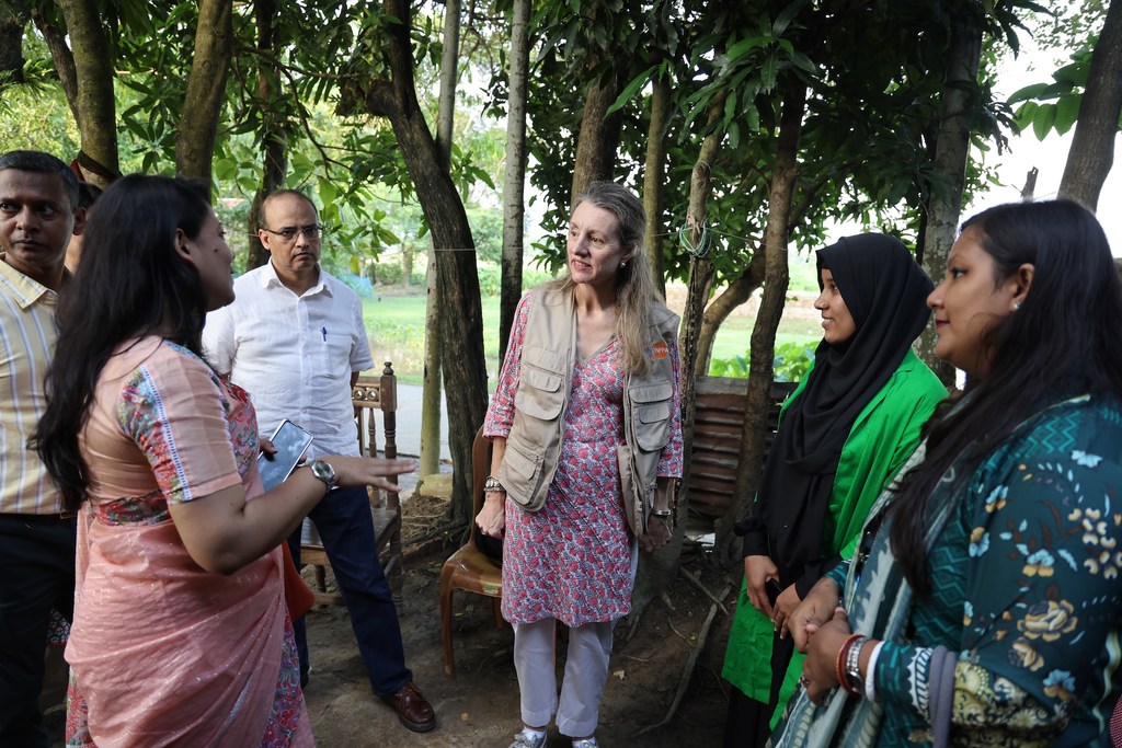 UNFPA Representative Catherine Breen Kamkong (centre) meets Shakila Begum (right, in green), a 26-year-old volunteer with the Climate Resilience Health System and Community Project in Sunamganj.