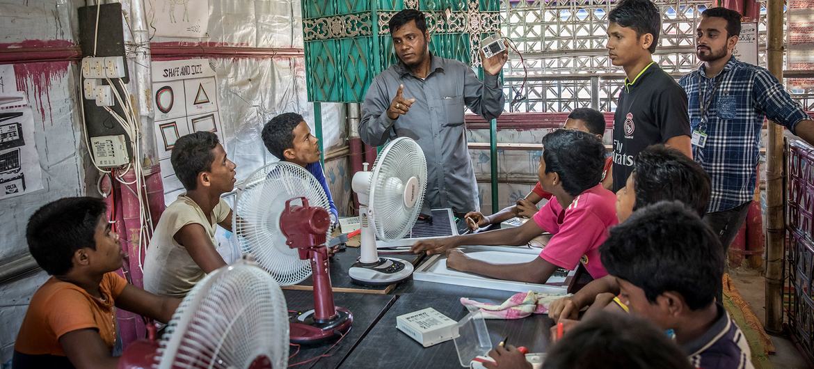 Young men from the Rohingya community receive electrician training at a refugee camp in southern Bangladesh.