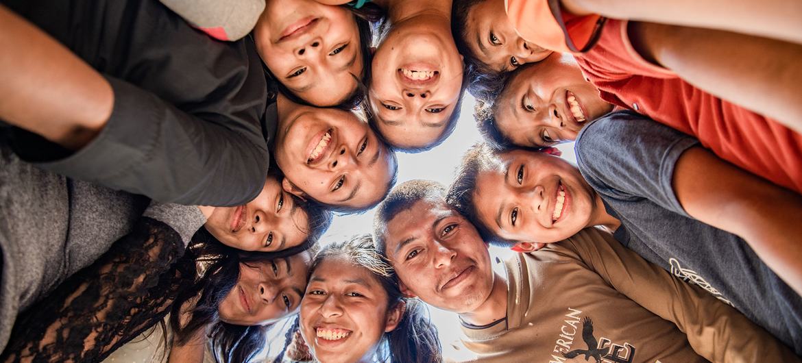 A group of teenagers gather to play football in San Cristobal, Alta Verapaz, Guatemala.
