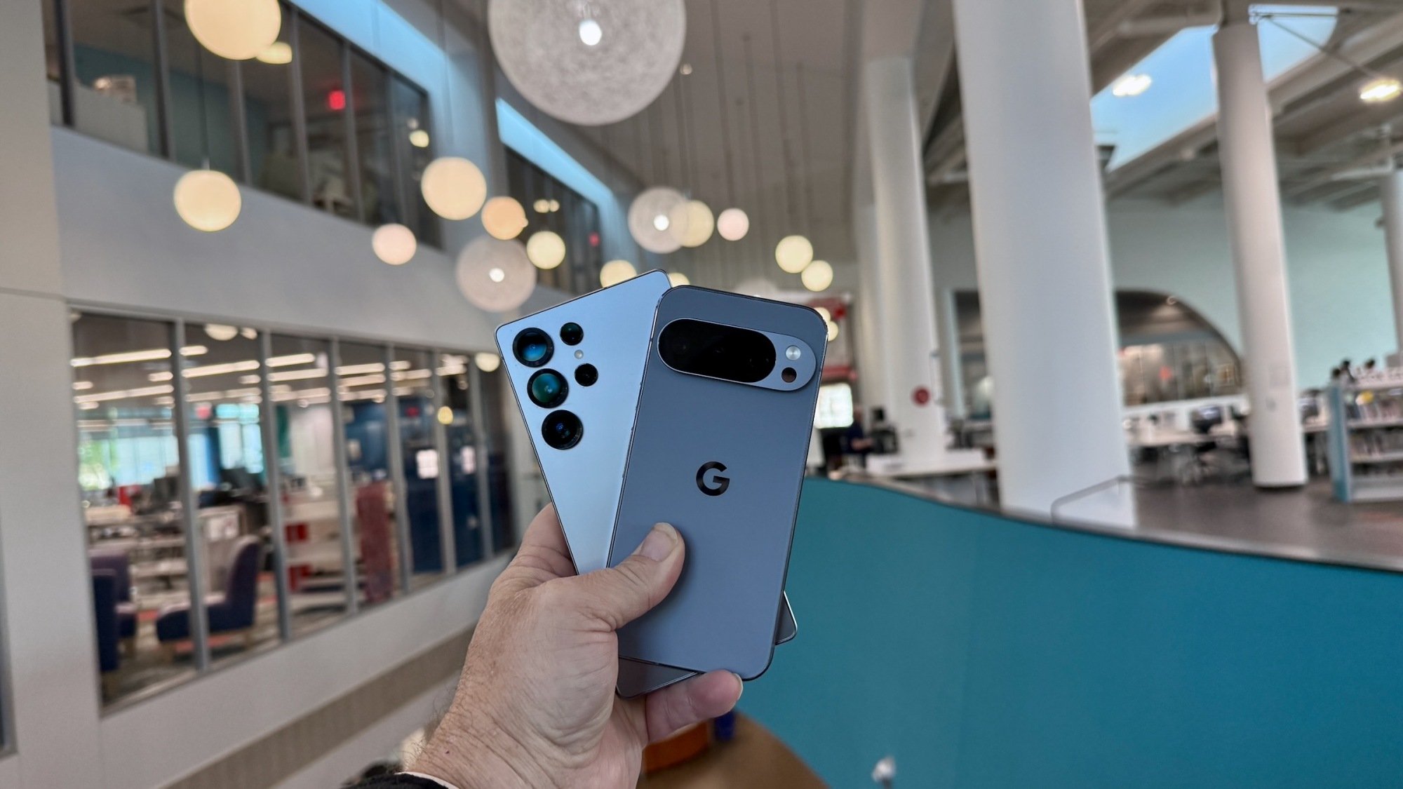 the pixel 10 pro and galaxy s25 ultra held in hand