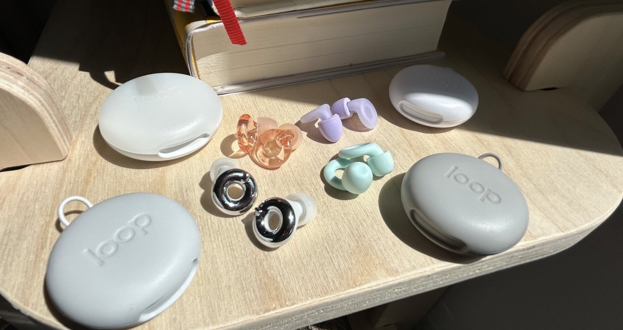loop earplugs and cases on a bookshelf